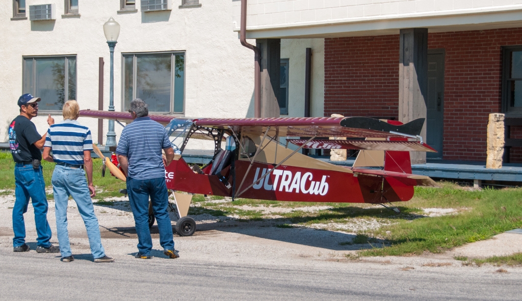 Guys looking at a Belite Ultralight airplane.